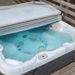 Square hot tub with cover half open