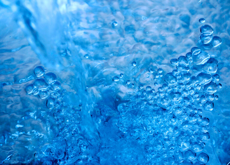 Abstract photo of blue toned pouring water.